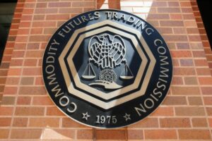 a sign on a brick wall that says community futures trading commission