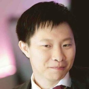 a man in a suit and tie looking at the camera