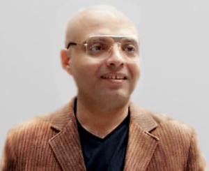 a man with glasses and a suit jacket