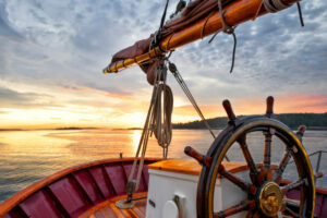 the wheel of a boat on a body of water