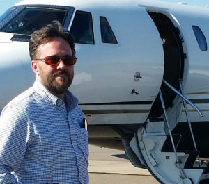 a man standing in front of an airplane