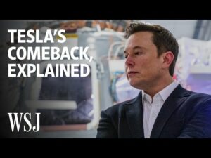 a man in a suit and tie standing in front of a wall