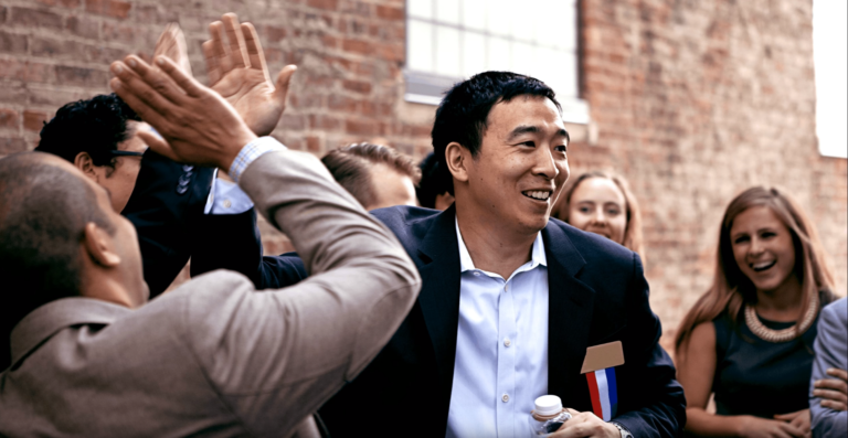 a group of people standing around each other