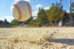 a baseball is hitting a ball in the dirt