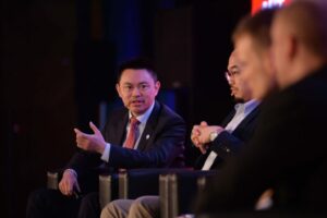 a group of three men sitting next to each other