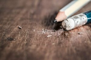 a close up of a pencil on a wooden table