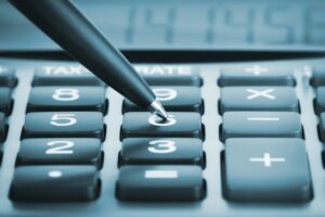 a pen is sitting on top of a calculator