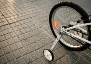 a white bicycle with a wheel on the ground