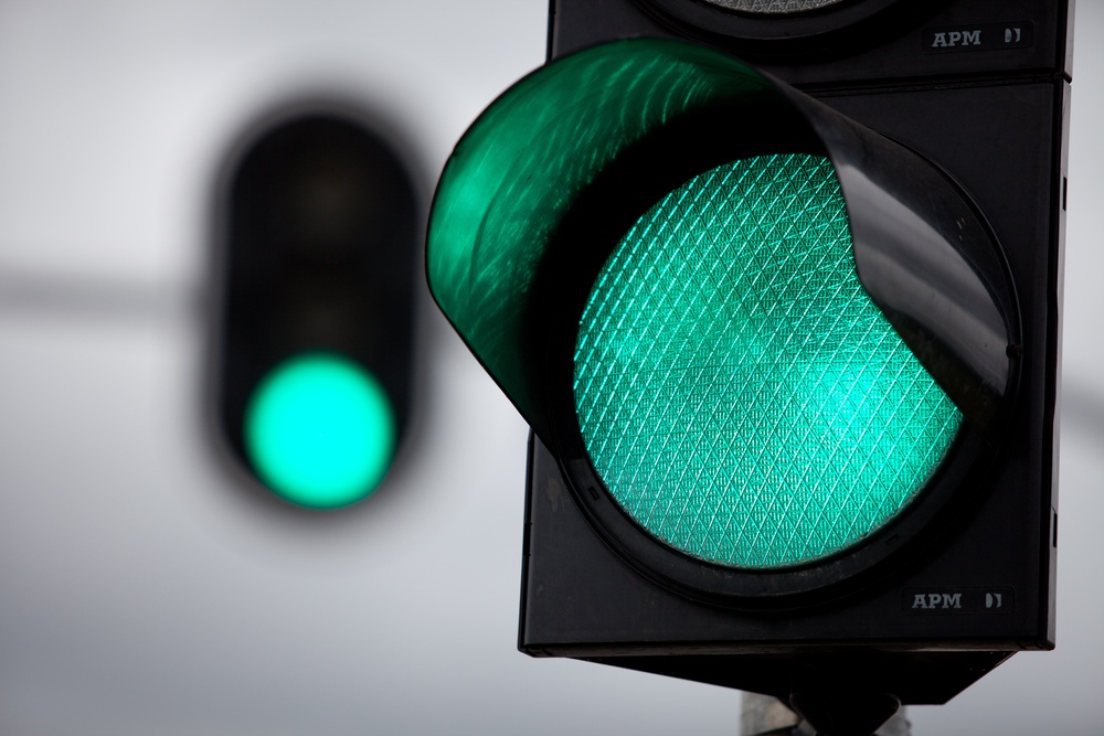 a close up of a traffic light with a green light