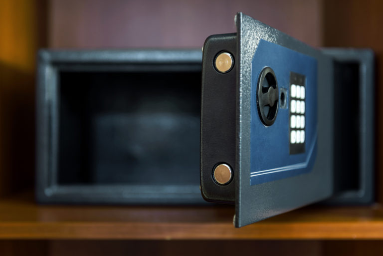 a close up of a black microwave on a wooden shelf