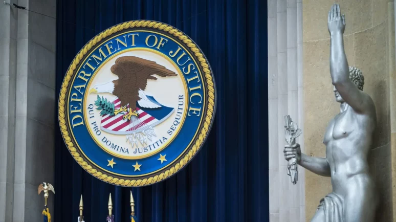 Department of Justice logo with a statue