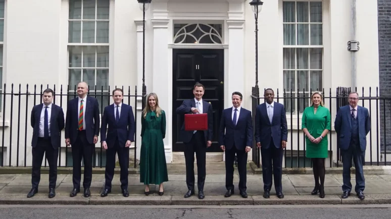 UK MPs standing on Downing Street in a row.