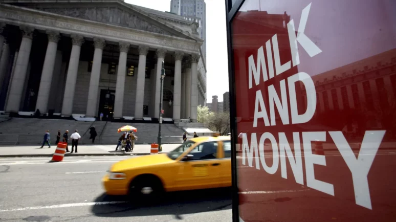 New York Supreme court in background, "Milk and Money" on bus stop advert.