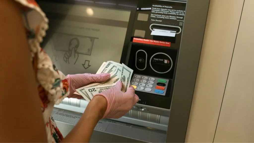 A woman withdrawing cash from an ATM